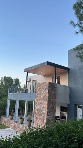 a building with two windows in front of it at Altos del Oeste in Villa Carlos Paz