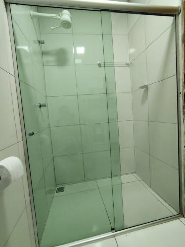 a shower with a glass door in a bathroom at Casa Vivah in Lençóis