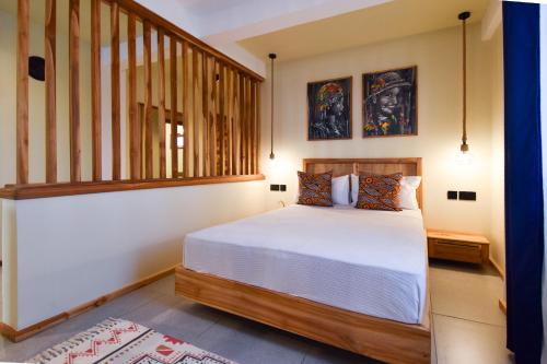 a bedroom with a large bed and a staircase at Castle Residence by Aura Space in Paje