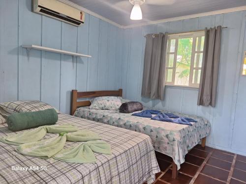 En eller flere senge i et værelse på Pousada Mamangaba de Ubá