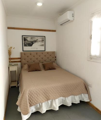 a bedroom with a bed in a white room at Temporario CNQ in Corrientes