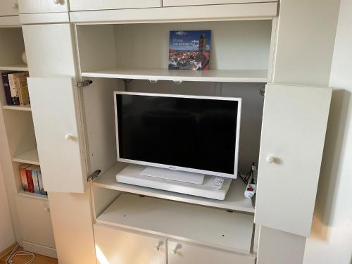 a white book shelf with a tv in it at Marienkirche 1 - ABC335 in Wismar