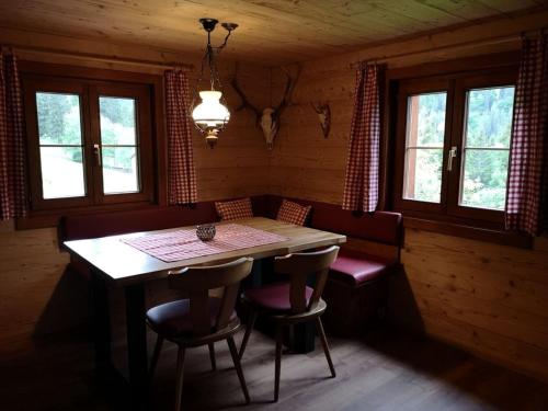a dining room with a table and chairs in a cabin at Hütta Monika in Sankt Gallenkirch