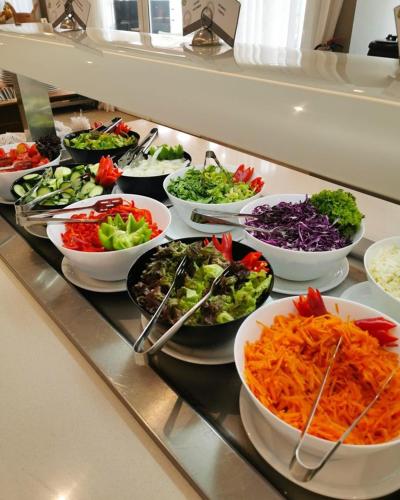 a buffet line with bowls of salads and vegetables at Baku Khatai Hotel & Restaurant in Baku