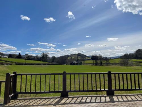 a park bench with a view of a field at Swn yr Coed in Sennybridge