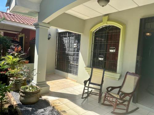 two chairs sitting on a porch of a house at Casa Doña Anita in León
