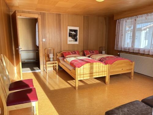 a bedroom with a bed with red pillows on it at Easy Central Stay with Parking in Grächen
