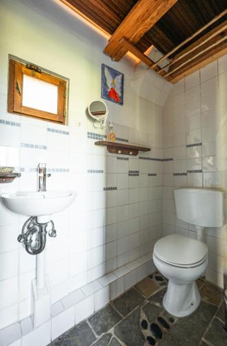 a bathroom with a toilet and a sink at Madeira-Meerblick-Haus in Estreito da Calheta