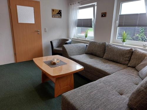 a living room with a couch and a coffee table at Ferienhaus Thiess - ABC402 in Wismar