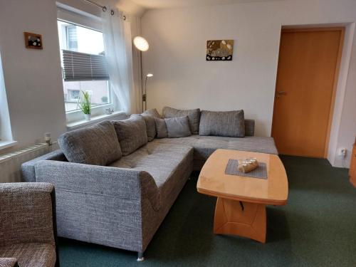 a living room with a couch and a coffee table at Ferienhaus Thiess - ABC402 in Wismar