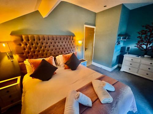 a bedroom with a large bed with towels on it at High Street Apartment in Windermere