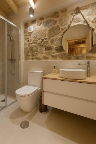 a bathroom with a toilet and a sink and a shower at Uíma River House in Lobão