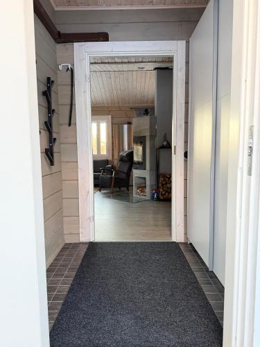 a hallway leading into a living room with an open door at Honkamaja, Aavasaksa, Lappi, Lapland in Aavasaksa