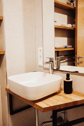 a bathroom with a white sink and a mirror at Pine apartment Vlašić in Vlasic