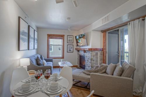 a living room with a table and chairs and a fireplace at Rimfire 342: Memory Maker, Walk to Shops, Slope Side in Slaty Fork