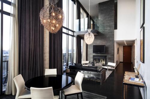 a dining room with a table and chairs and a fireplace at Sixty LES in New York