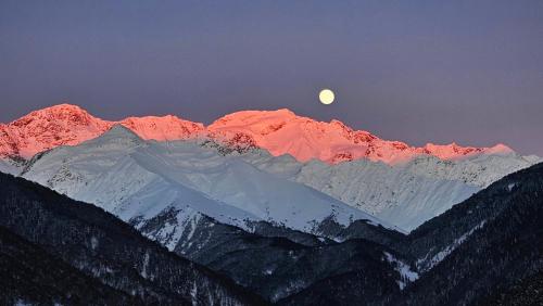 a mountain range with the moon in the background at Mountain Shadow Cottage in Racha in Ghebi