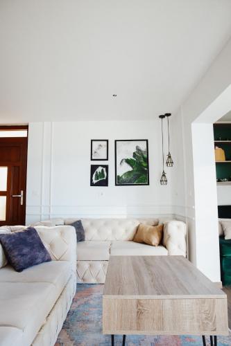 a living room with a white couch and a coffee table at Pine apartment Vlašić in Vlasic