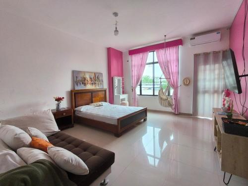 a living room with a bed and a couch at Enchanted Haven in Puerto Baquerizo Moreno