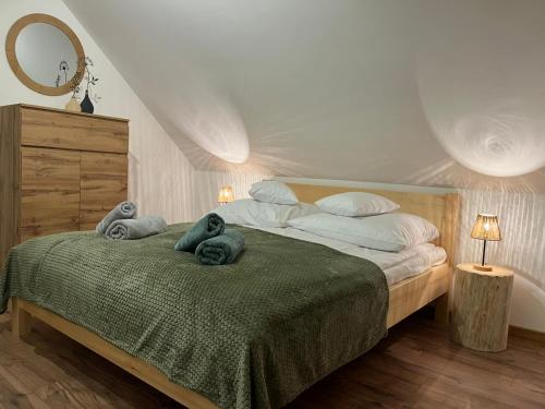 a bedroom with a bed with towels on it at Na szlaku Baraniej Góry in Istebna