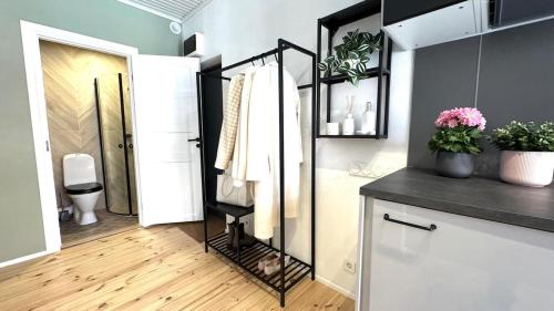 a bathroom with a sink and a toilet in a room at Bohemian Chic apartment in Kalamaja in Tallinn