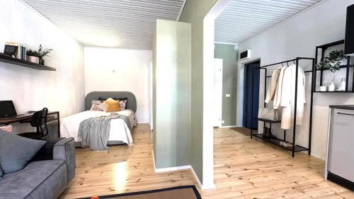 a living room with a bed and a couch at Bohemian Chic apartment in Kalamaja in Tallinn