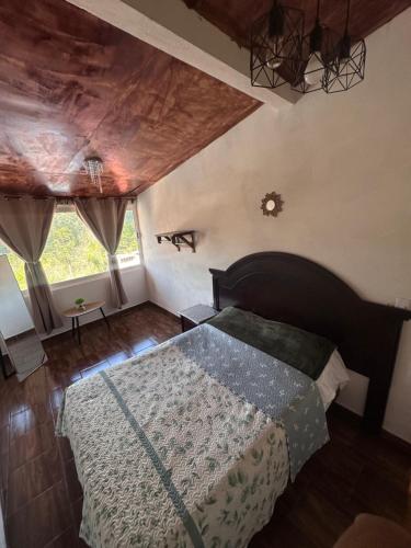 a bedroom with a large bed in a room at El Refugio del Viajero in Mineral del Chico