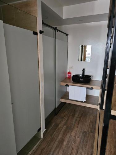 a bathroom with a sink and a mirror at Apartaestudio in Cali
