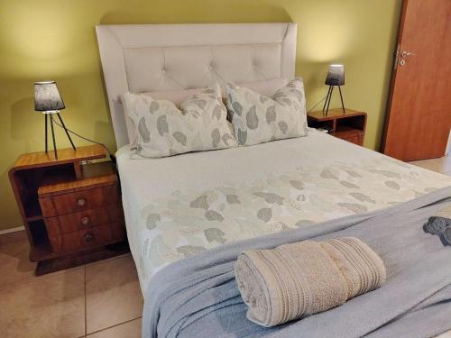 a bedroom with a large bed with two night stands at Depto Viamonte PlantaAlta, 2Dorm, Terraza, Cochera in Cordoba