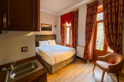 a bedroom with a bed and a sink at BeyPort Hotel Istanbul in Istanbul