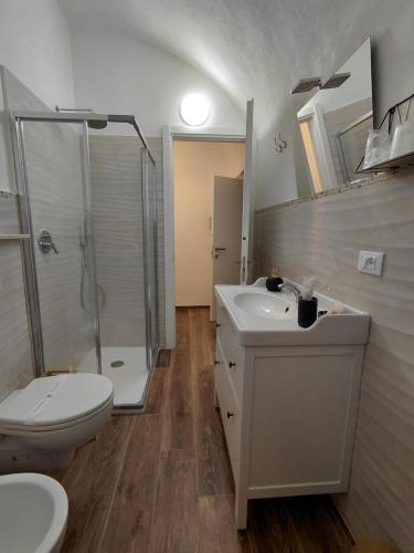 a bathroom with a toilet and a sink and a shower at La Ginestra in Bastia