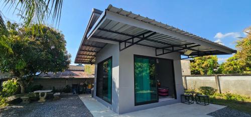 a small house with a modern roof at ST house in Ban Nua Khlong
