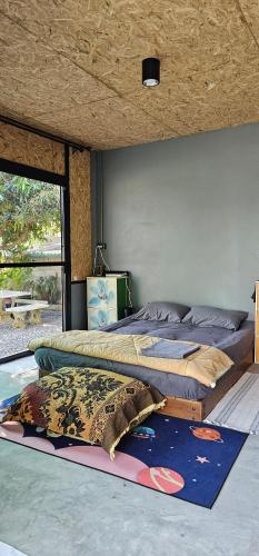 a bedroom with two beds and a rug on the floor at ST house in Ban Nua Khlong