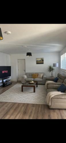 a living room with a couch and a table at Shangri-La Large Family Townhouse free carpark in Killarney