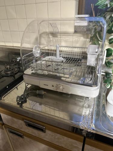 a dish washer sitting on top of a kitchen counter at Guest House "Ro"Ikura in Shimonoseki