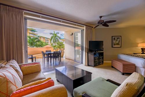 a living room with a couch and a living room with a balcony at Honua Kai H237 in Lahaina