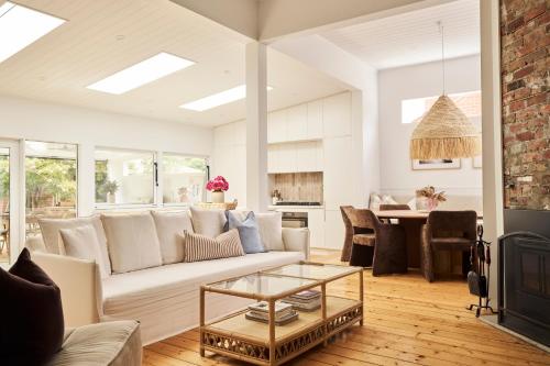 a living room with a couch and a table at Zalm Bendigo in Bendigo