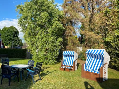 two blue and white chairs and a table and chairs at Darßwaldradler in Wieck