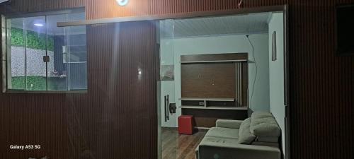 a living room with a couch and a window at Fundilhos House in Rio das Ostras