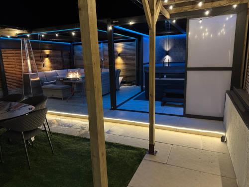 a living room with a patio at night at 5 Bed Town House With Additional Luxury Hot Tub And Within City Centre And Sleeps Up To 11 With Sky And Netflix in Birmingham