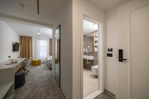 a hotel room with a bathroom with a toilet and a sink at Hotel Opal Casa in Novi Pazar