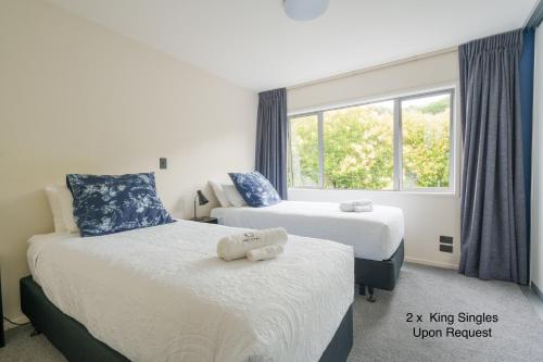 a hotel room with two beds and a window at 3 BDR CBD Get Away in Auckland