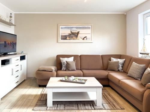 a living room with a couch and a coffee table at Kleiner Seehund in Groß Kirr