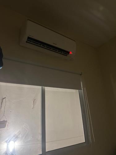 a room with a window with a air conditioner on the ceiling at A casa do Breno in São José da Coroa Grande
