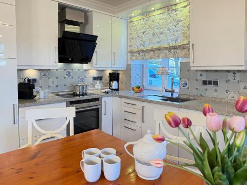 a kitchen with a wooden table with a vase on it at Ruheoase in Prerow