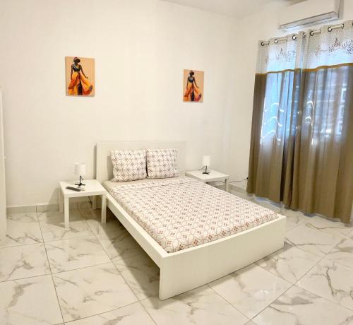 En eller flere senge i et værelse på Hamjago