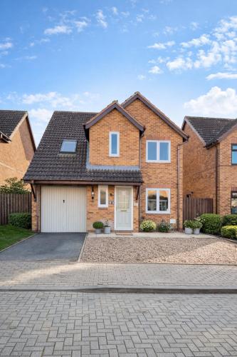 a brick house with a driveway at Champflower House- Sleeps 7- Driveway Parking, Contractors, Fast Wifi and Smart TV in Milton Keynes