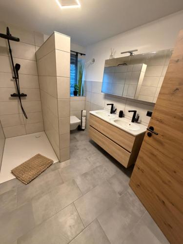 a bathroom with a tub and a sink and a shower at Ferienwohnungen Rauch in Regen