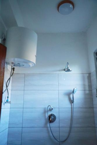 a bathroom with a shower with a shower head at Kings Land Hotel in Lalibela