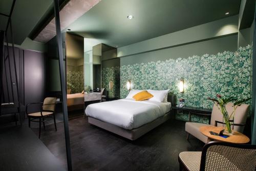 a hotel room with a bed and a table and chairs at BROWN DOT Hotel Dadaepo Beach in Busan